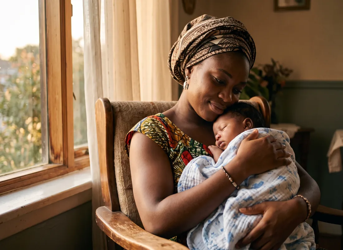 Placeholder — replace with photo: Nigerian mother holding her newborn, warm natural light